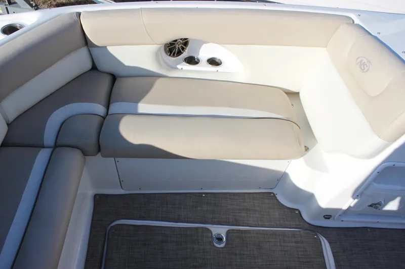 Slide: The Image of 2018 NauticStar 243DC Sport Deck interior with beige seating and speaker system. - 8