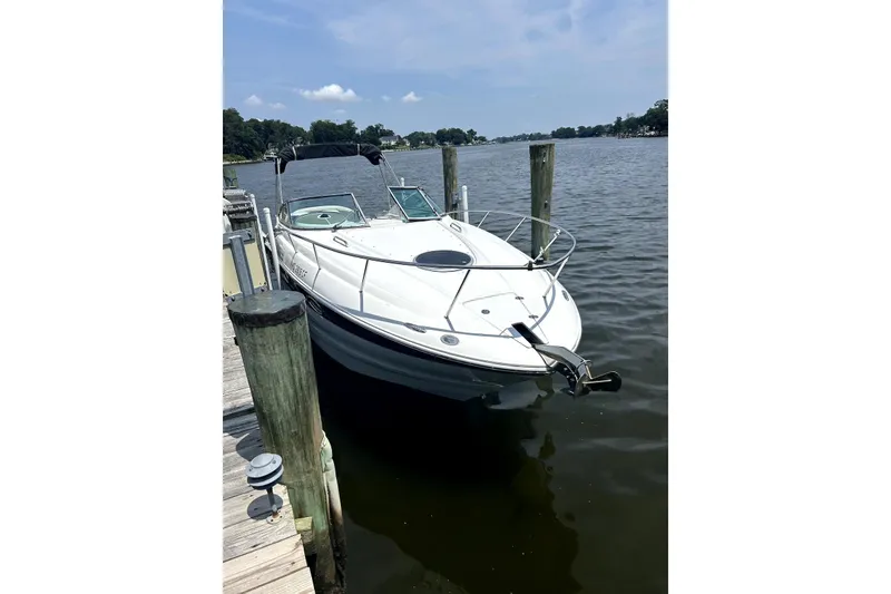 The Image of 2012 Crownline 260 CR boat docked on a lift by the water. - 0