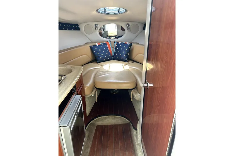 Slide: The Image of 2012 Crownline 260 CR boat side view with logo, docked on water. - 10