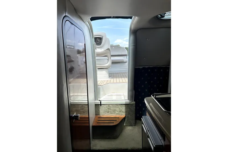 Slide: The Image of Interior of 2012 Crownline 260 CR boat with cozy seating and nautical decor. - 13