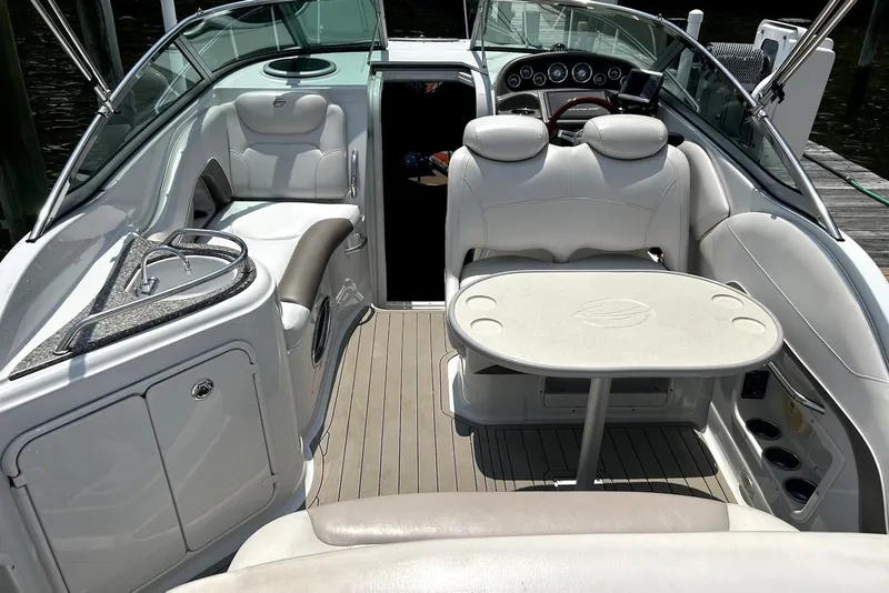 Slide: The Image of 2012 Crownline 260 CR boat docked at a marina, featuring sleek design and comfortable seating. - 3