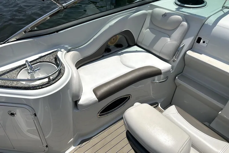 Slide: The Image of 2012 Crownline 260 CR boat interior with seating, table, and dashboard. - 5