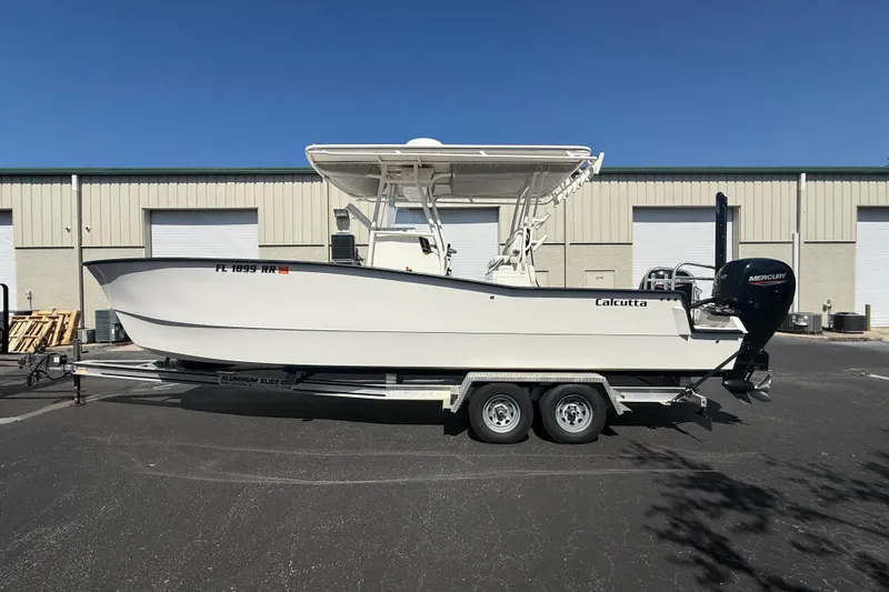 The Image of 2019 Calcutta 263 boat on trailer, parked outside industrial building. - 1