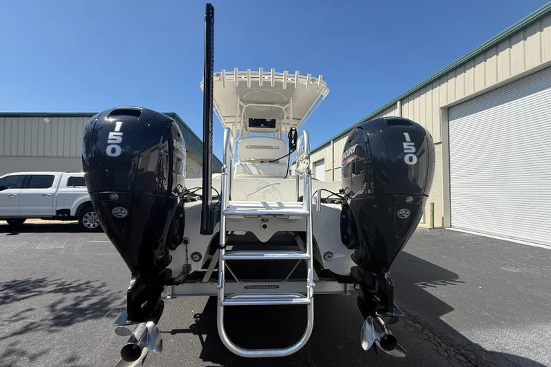 Slide: The Image of 2019 Calcutta 263 boat with dual Mercury 150 engines, parked outdoors. - 14