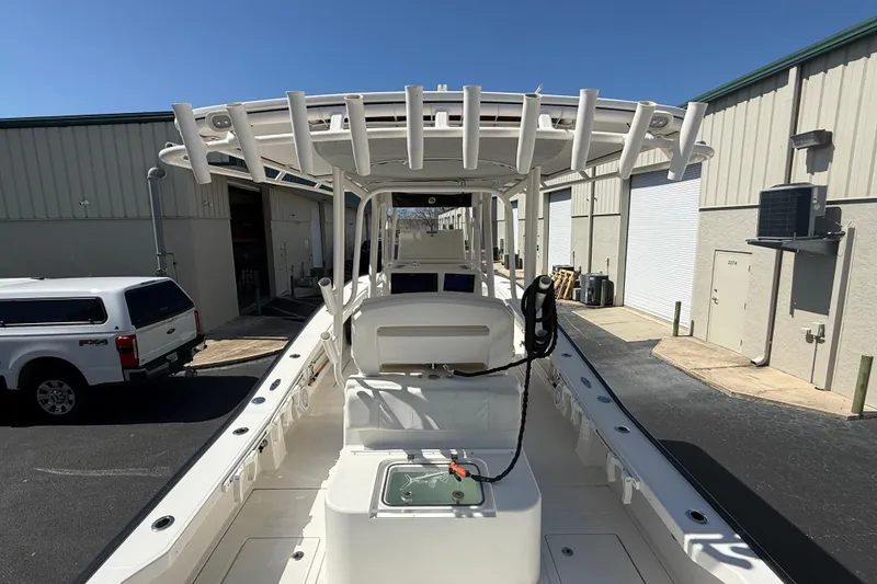 Slide: The Image of 2019 Calcutta 263 boat with T-top, docked near industrial buildings. - 23