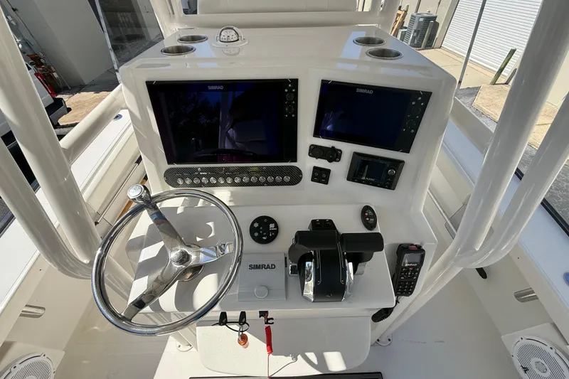 Slide: The Image of 2019 Calcutta 263 boat dashboard with dual Simrad displays and steering wheel. - 31