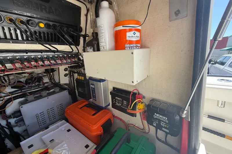 Slide: The Image of Electrical panel and storage in a 2019 Calcutta 263 boat, featuring wiring and equipment. - 44
