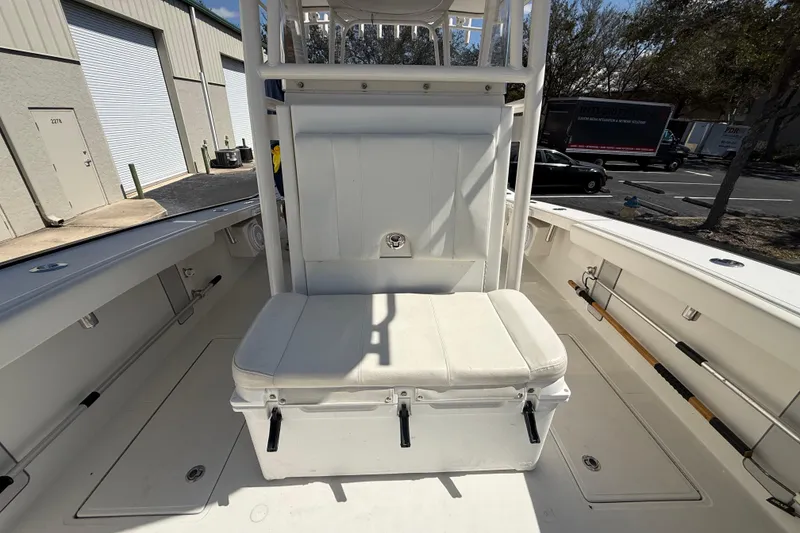 Slide: The Image of 2019 Calcutta 263 boat interior with white seating and storage, parked outdoors. - 45