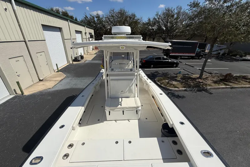 Slide: The Image of 2019 Calcutta 263 boat docked near industrial buildings, sunny day. - 49