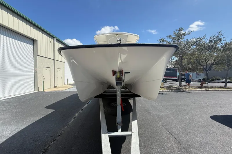 Slide: The Image of 2019 Calcutta 263 boat on trailer, parked outside industrial building under clear sky. - 5