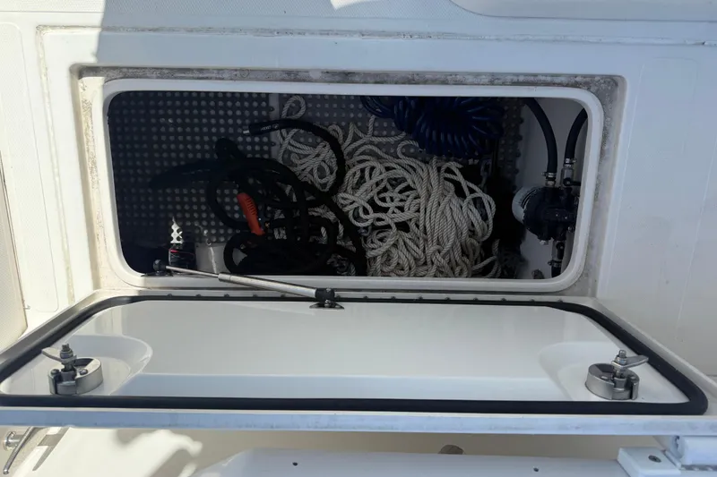 Slide: The Image of Open storage compartment on 2019 Calcutta 263 boat with ropes and equipment. - 68