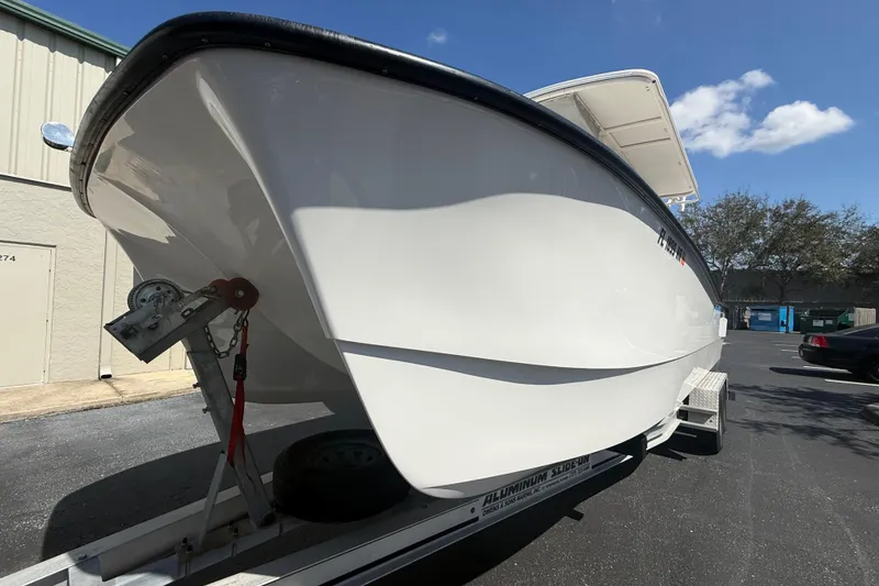 Slide: The Image of 2019 Calcutta 263 boat on trailer, parked outdoors under clear sky. - 7