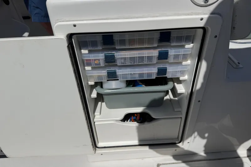 Slide: The Image of Storage compartment on a 2019 Calcutta 263 boat with organized tackle boxes. - 70