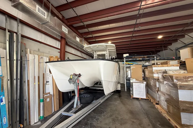 Slide: The Image of 2019 Calcutta 263 boat stored in a warehouse with boxes and materials. - 76