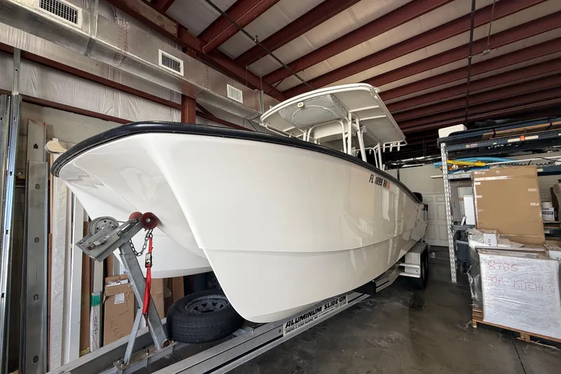 Slide: The Image of 2019 Calcutta 263 boat stored indoors on a trailer in a warehouse. - 77