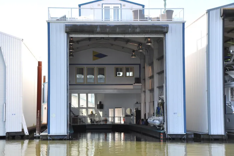 The Image of Steelhead Marine Boat House, 2004 model, with open entrance and interior view over water. - 0