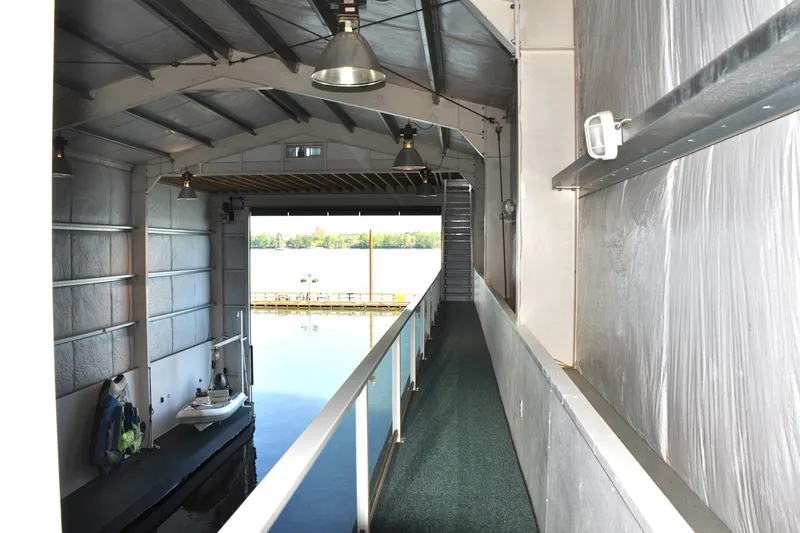 Slide: The Image of Interior of a 2004 Steelhead Marine Boat House with water view and walkway. - 11