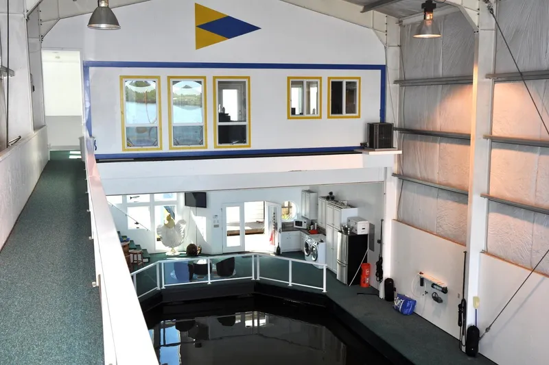 Slide: The Image of Interior of a 2004 Steelhead Marine Boat House with modern amenities and dock area. - 13