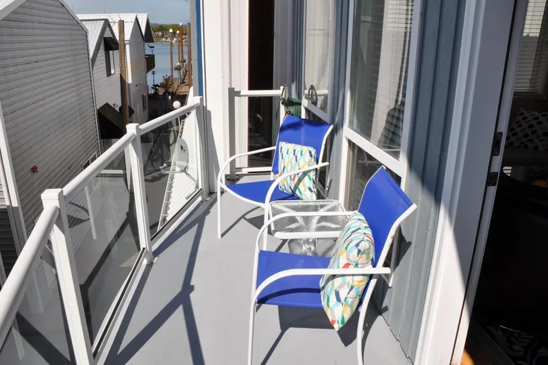 Slide: The Image of Balcony of 2004 Steelhead Marine Boat House with blue chairs and colorful cushions. - 15