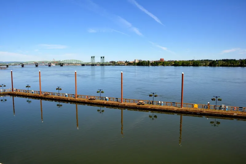 Slide: The Image of River view with a long dock, bridge, and clear blue sky. Steelhead Marine Boat House, 2004. - 25