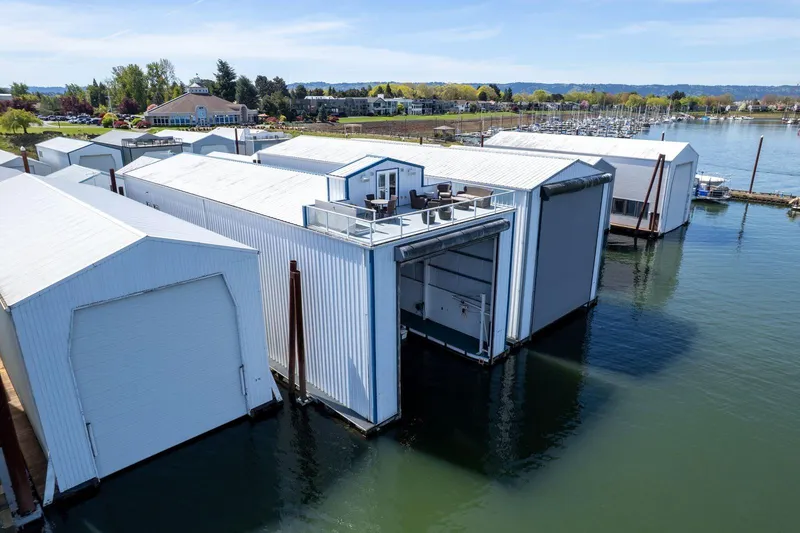 Slide: The Image of Floating boathouse with rooftop deck on calm water, surrounded by scenic landscape. - 29