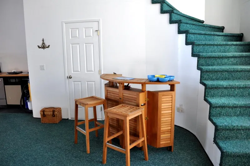 Slide: The Image of Cozy interior of 2004 Steelhead Marine Boat House with wooden bar and green carpeted stairs. - 7