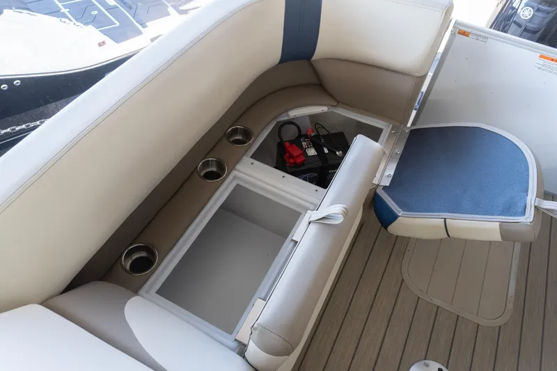 Slide: The Image of 2026 SunCatcher Select 322RC boat interior with storage compartment and cup holders. - 10