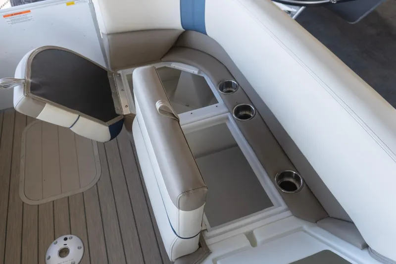 Slide: The Image of 2026 SunCatcher Select 322RC boat interior with seating and cup holders. - 11
