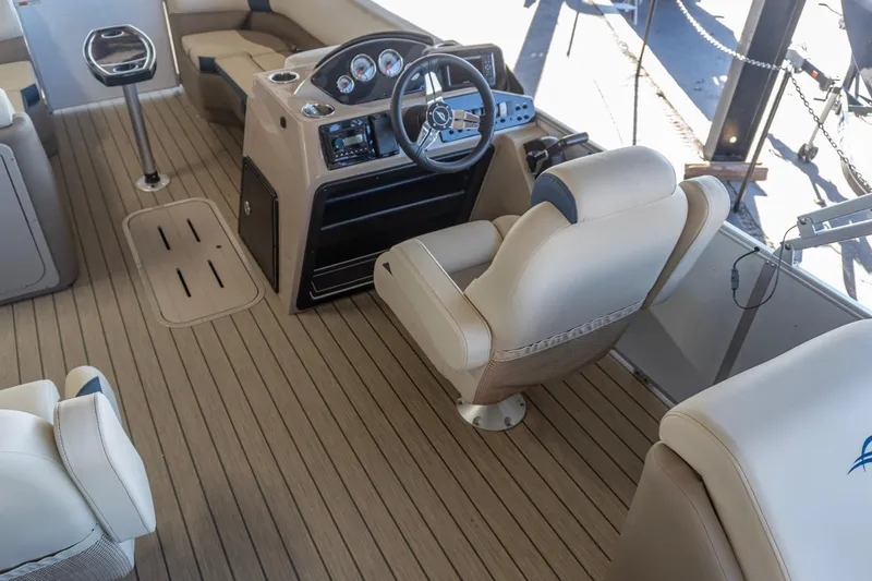 Slide: The Image of Interior of 2026 SunCatcher Select 322RC boat with modern helm and seating. - 15
