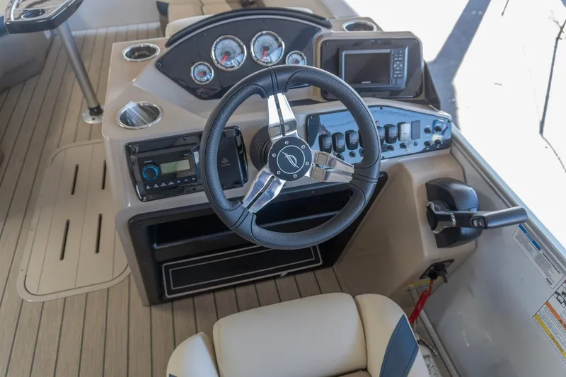 Slide: The Image of 2026 SunCatcher Select 322RC boat dashboard with steering wheel and control panel. - 16