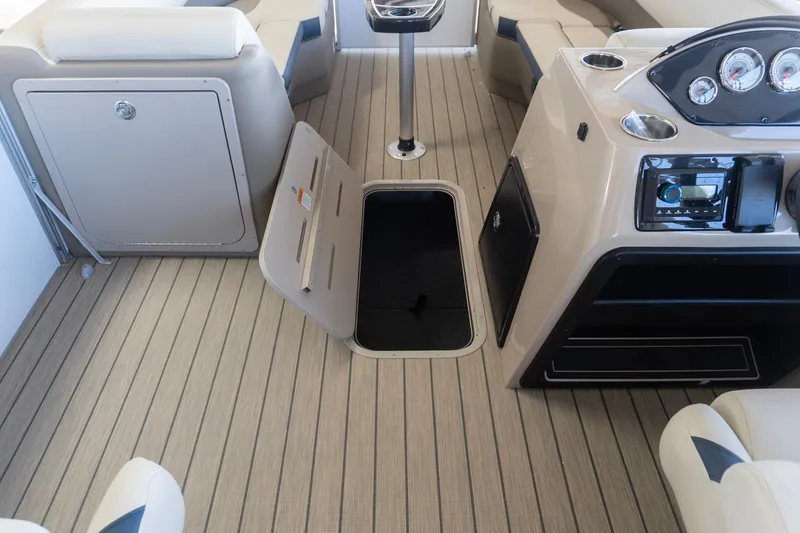 Slide: The Image of 2026 SunCatcher Select 322RC boat interior with open storage hatch and control panel. - 20
