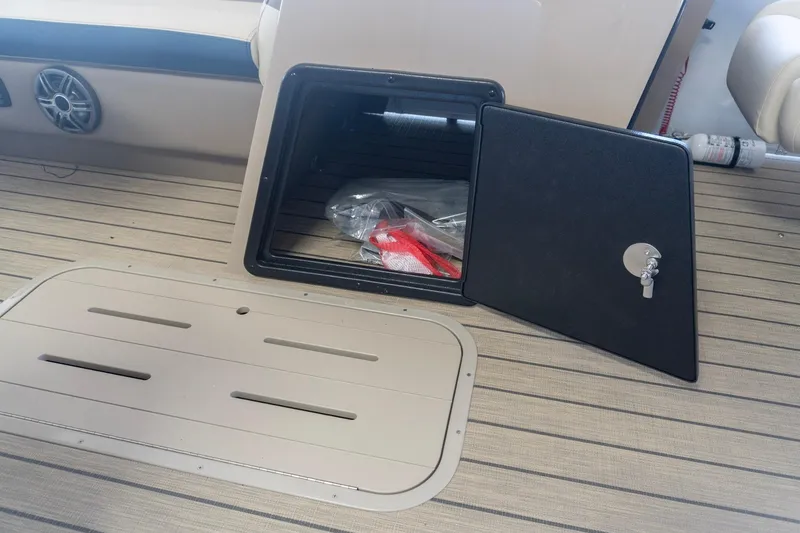 Slide: The Image of Open storage compartment on 2026 SunCatcher Select 322RC boat deck. - 21