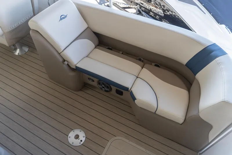 Slide: The Image of Luxurious seating on 2026 SunCatcher Select 322RC boat, featuring beige and blue upholstery. - 9
