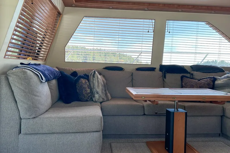 Slide: The Image of Luxurious 2004 West Bay Sonship yacht interior with plush seating and wooden blinds. - 13