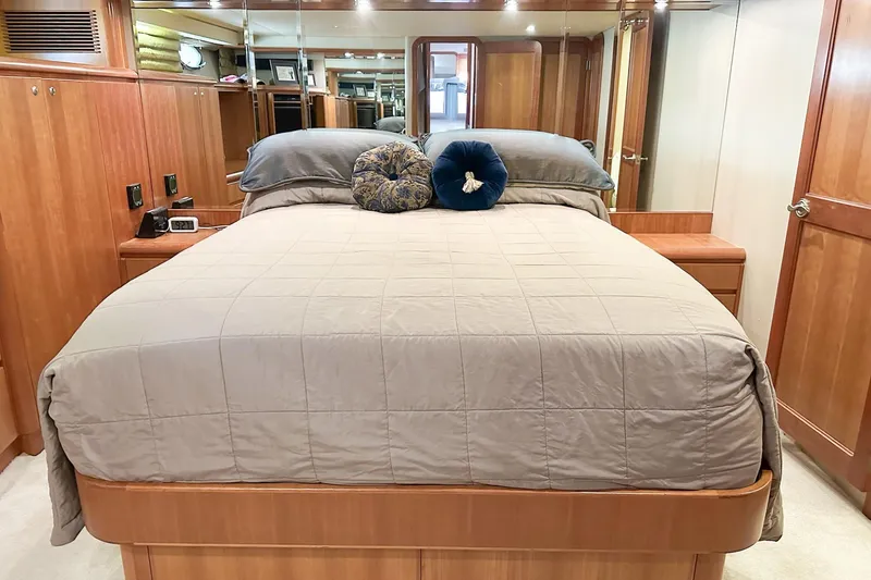 Slide: The Image of Luxurious 2004 West Bay Sonship yacht bedroom with elegant wood finishes and plush bedding. - 15
