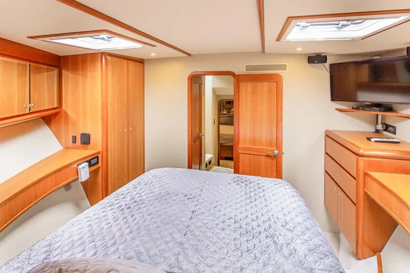 Slide: The Image of Luxurious 2004 West Bay Sonship yacht bedroom with wood accents and modern amenities. - 16