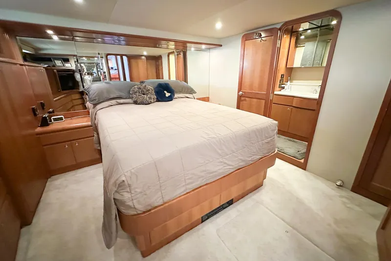 Slide: The Image of Luxurious 2004 West Bay Sonship yacht bedroom with elegant wood finishes and ensuite bathroom. - 17