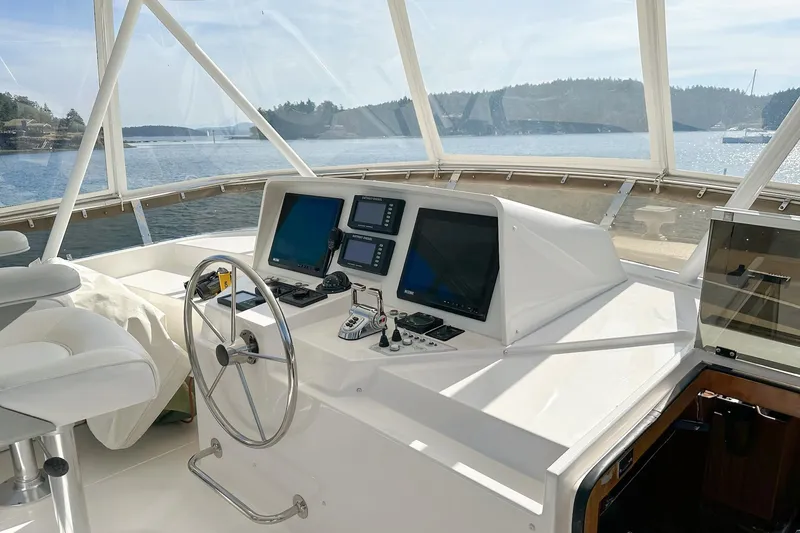 Slide: The Image of Helm of 2004 West Bay Sonship yacht with navigation screens and steering wheel. - 21