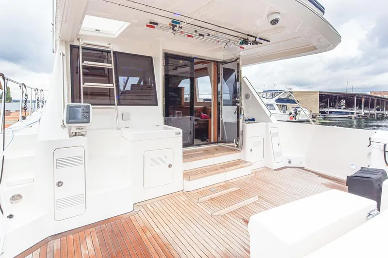 Slide: The Image of 2004 West Bay Sonship yacht deck with wooden flooring and modern amenities. - 22