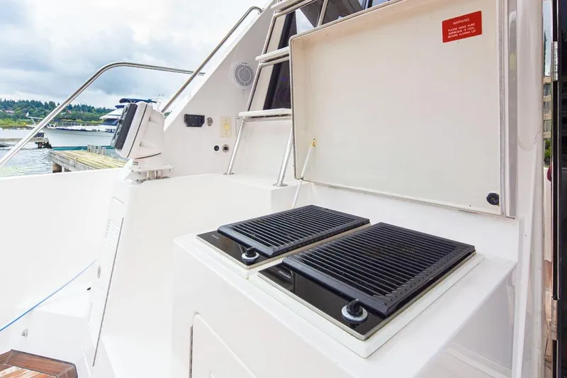 Slide: The Image of Outdoor grill on 2004 West Bay Sonship yacht deck, near marina. - 24