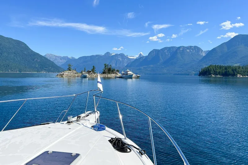 Slide: The Image of 2004 West Bay Sonship yacht cruising in scenic mountain lake with clear blue skies. - 5