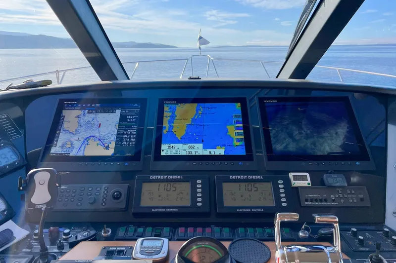 Slide: The Image of Cockpit view of 2004 West Bay Sonship yacht with navigation screens and controls. - 6