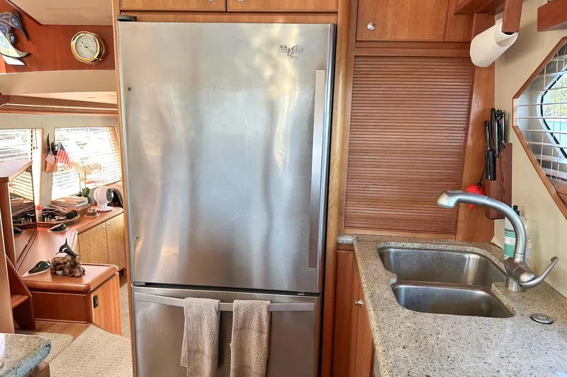 Slide: The Image of 2004 West Bay Sonship yacht kitchen with stainless steel fridge and sink. - 8
