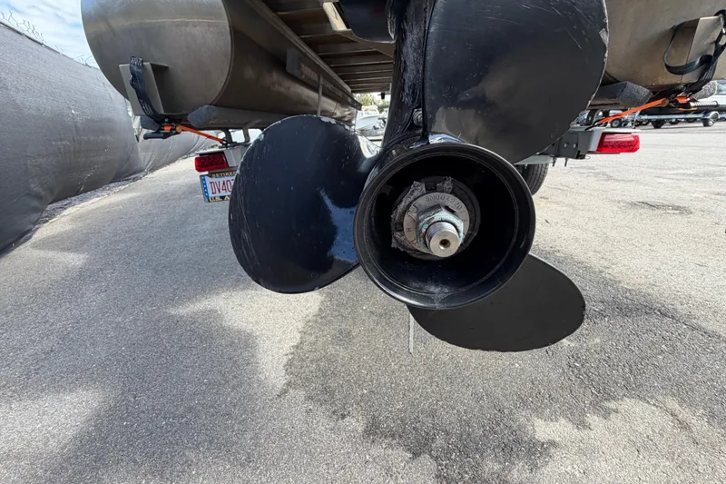 Slide: The Image of 2023 Lowe SS 210 boat propeller close-up on a trailer, asphalt background. - 11