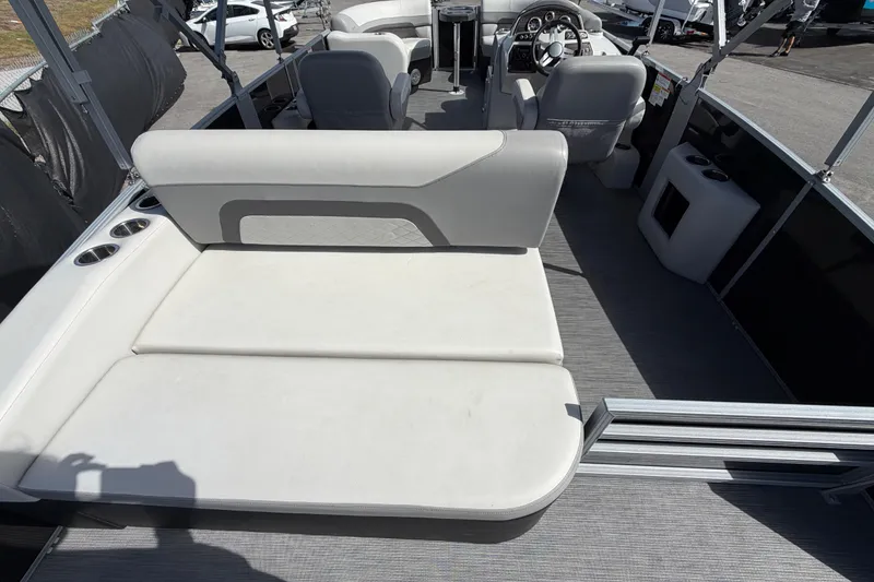 Slide: The Image of 2023 Lowe SS 210 pontoon boat interior with seating and steering console. - 14