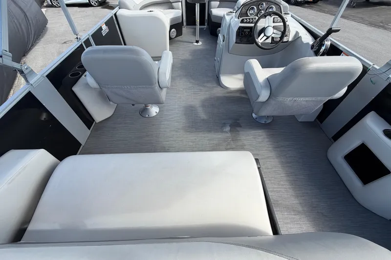 Slide: The Image of Interior of 2023 Lowe SS 210 pontoon boat with gray seating and steering console. - 17