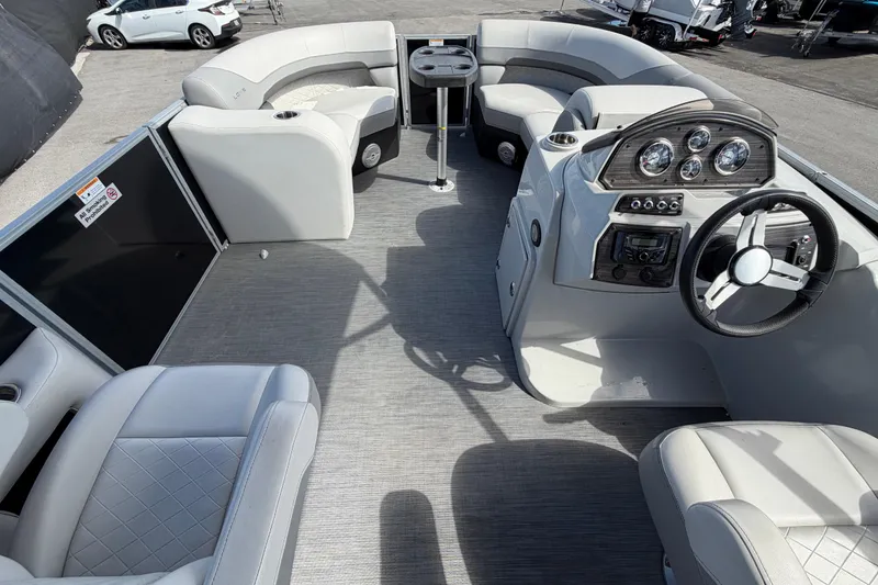 Slide: The Image of 2023 Lowe SS 210 pontoon boat interior with modern dashboard and seating. - 20