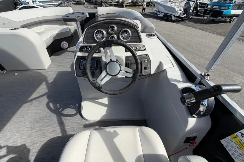 Slide: The Image of 2023 Lowe SS 210 boat interior with steering wheel and control panel. - 21