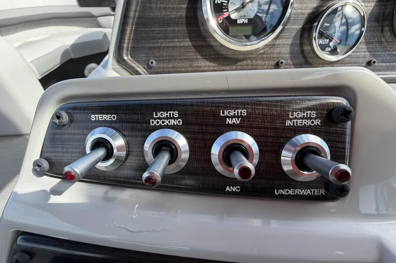 Slide: The Image of Control panel of 2023 Lowe SS 210 boat with switches for stereo and lights. - 24