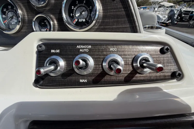 Slide: The Image of Control panel of 2023 Lowe SS 210 boat with switches and gauges. - 25